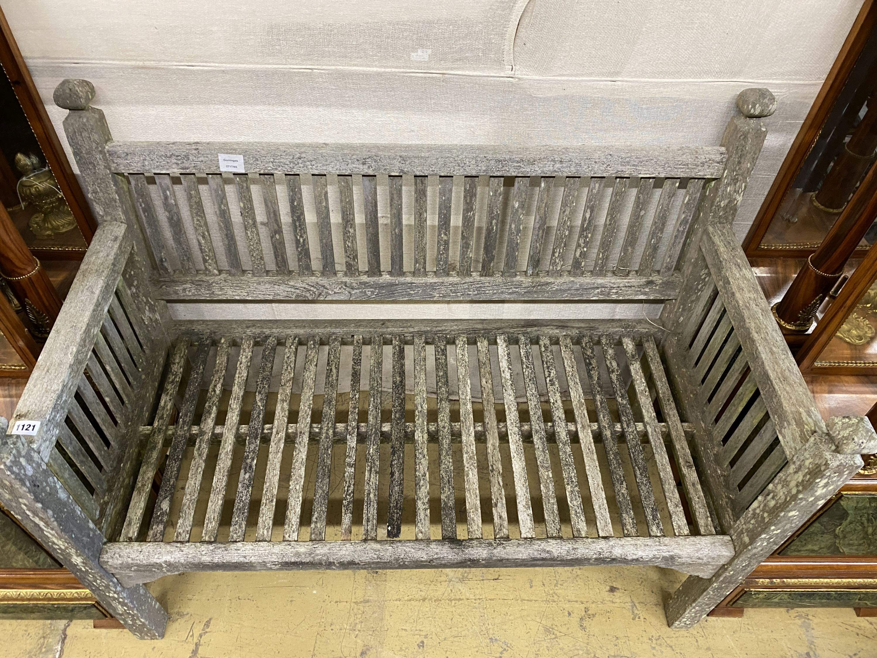 A small weathered teak slatted garden bench, length 114cm, depth 56cm, height 90cm